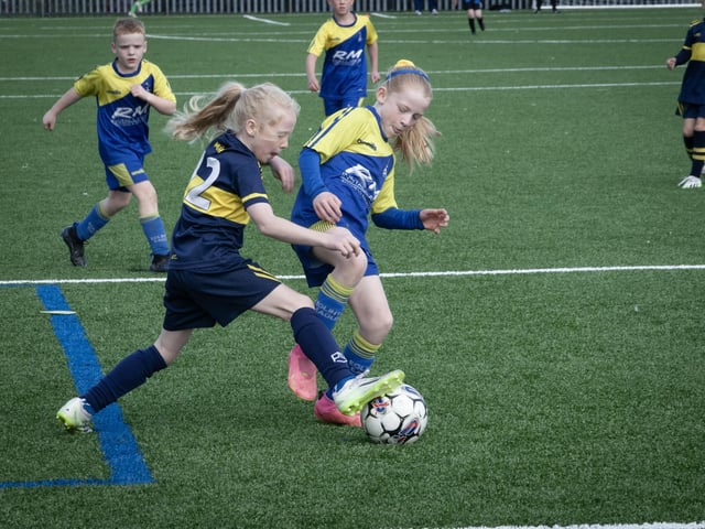 These young ladies show the boys how to tackle during Sunday's Sean O'Kane Memorial Tournament 2015 final between Don Bosos and Eglinton Eagles at St. Joseph's Boys School. (Photos: Jim McCafferty Photography)