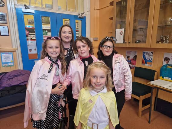 Classroom assistant Emma Courtney with Grace, Eve, Zara-Mae and Kayleigh, who all dressed up as the Pink Ladies in aid of the Pink Ladies Cancer Support Group.