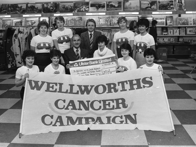 Wellworths staff present cheque to Mr D. Whyte for Cancer Research.