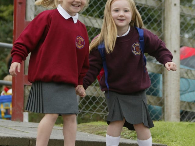 Chloe McCafferty and her friend Orlagh McCloskey are all smiles as they go to St. mary's PS, Cloughcor for their first day at school. (0209JB65). pic. Joe Boland:20 YEARS ON: Pictures of Derry children starting primary 1 in September 2003