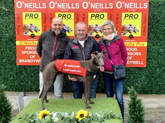 Olwinn Swift pictured with winning owner, Oliver Canavan (centre) and guests from Germany who were at their first ever greyhound meeting; Markus and Heike Graskamp.