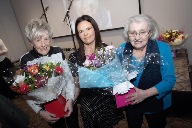 LONG-SERVICE RECOGNITION. . . .Aine Barton presents bouquets of flowers to Jeanette Warke and Mary Nelis during Friday's Féile 'International Womens' Day' event at the Maldron Hotel. The ladies were recognised for their long-serving contribution to the development and change they have made to their communities. (Photos: Jim McCafferty Photography)
