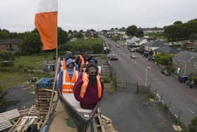 MOYGASHEL, JULY 10: A model of a small boat with several figures depicting migrants inside can be seen on top of a loyalist bonfire on July 10, 2025 in Moygashel. Loyalists have constructed a bonfire effigy depicting a boat full of migrants with mannequins wearing lifejackets and placards reading "Stop the boats," and "Veterans before refugees." The effigy was burned atop a pyre of pallets on Thursday night. Moygashel Bonfire Committee has said that the bonfire "topper" should not be seen as "racist, threatening or offensive" and it was "expressing our disgust at the ongoing crisis that is illegal immigration". (Photo by Charles McQuillan/Getty Images)