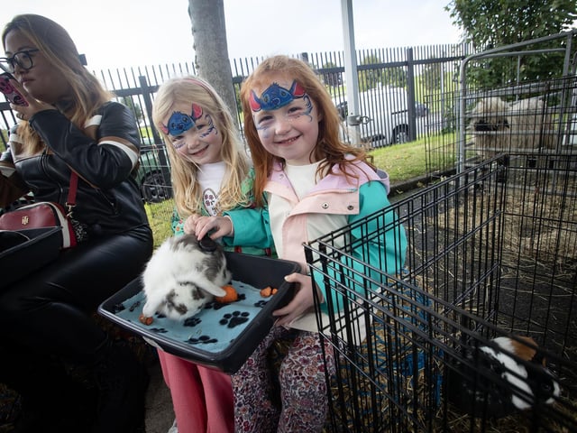 Two young ladies looking after one of the rabbits on Saturday.