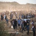 People carry relief supplies from the Gaza Humanitarian Foundation (GHF), a private US-backed aid group that has bypassed the longstanding UN-led system in the territory, as displaced Palestinians return from an aid distribution centre in the central Gaza Strip on June 8, 2025. The UN and major aid organisations have refused to cooperate with the GHF, citing concerns that it was designed to cater to Israeli military objectives. (Photo by Eyad BABA / AFP) (Photo by EYAD BABA/AFP via Getty Images)