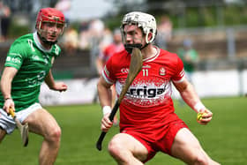 Cormac O'Doherty of Derry shields the sloithar from London's Robbie Murphy . Photo: George Sweeney