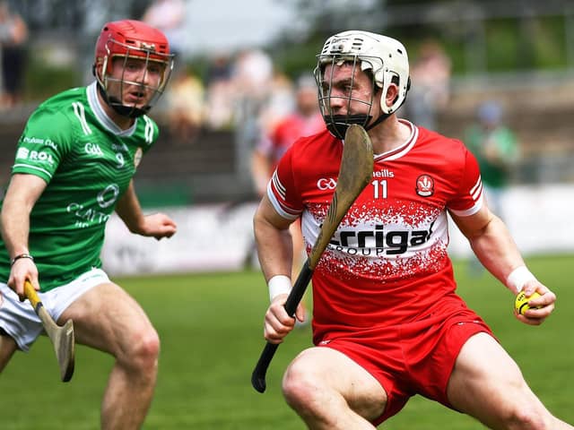 Cormac O'Doherty of Derry shields the sloithar from London's Robbie Murphy . Photo: George Sweeney