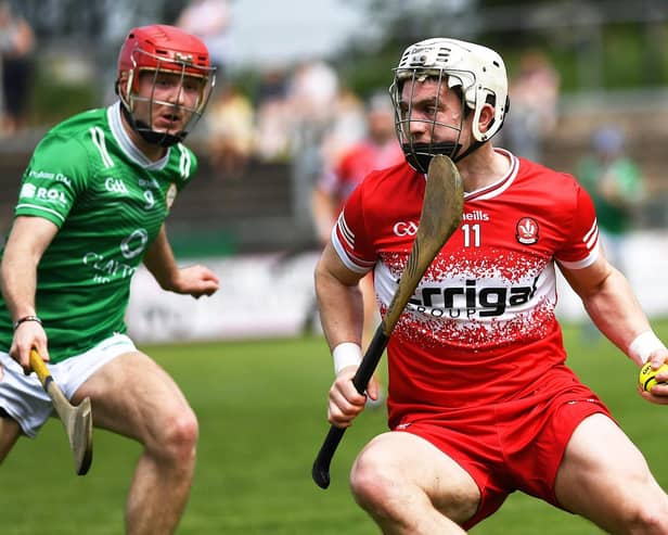 Cormac O'Doherty of Derry shields the sloithar from London's Robbie Murphy . Photo: George Sweeney