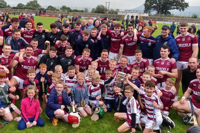 Slaughtneil players and supporters celebrate their Derry senior hurling championship win at Owenbeg on Sunday.