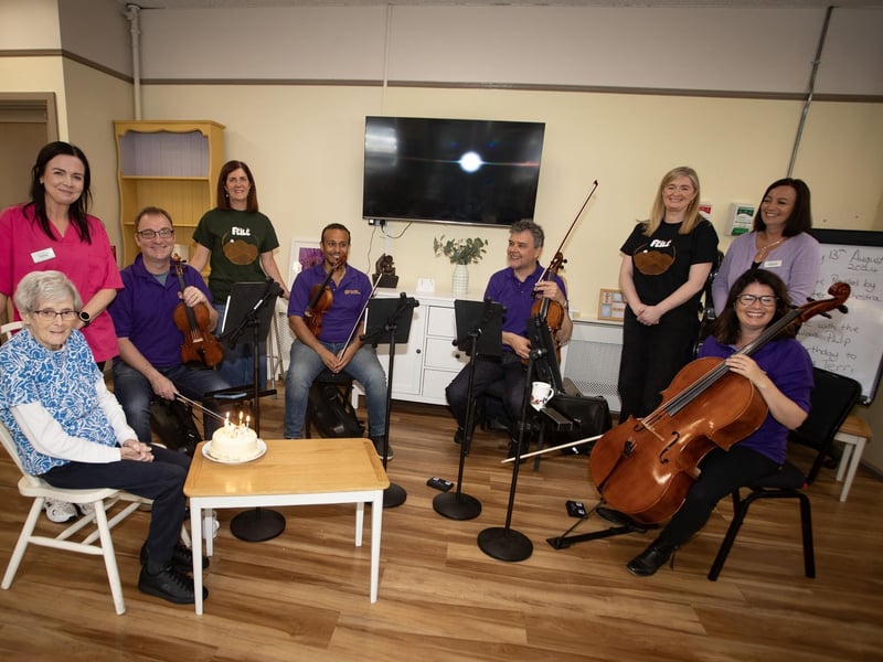 Members of the Ulster Orchestra sing happy birthday to Josie  at the Creggan Day Centre on Tuesday morning. The group were there performing as part of Féile 24. (Photos: Jim McCafferty Photography)