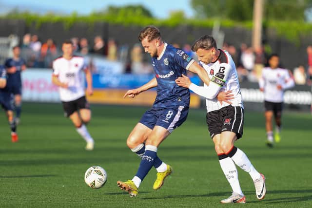 Will Patching holds off his man at Oriel Park during Derry's scoreless draw against Dundalk. Photograph by Kevin Moore.