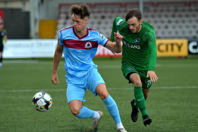 Institute’s Michael Harris gets to the ball ahead of Newington’s Seamus Duffy during Saturday’s game in the Brandywell.  Photograph: George Sweeney. DER2333GS – 90  