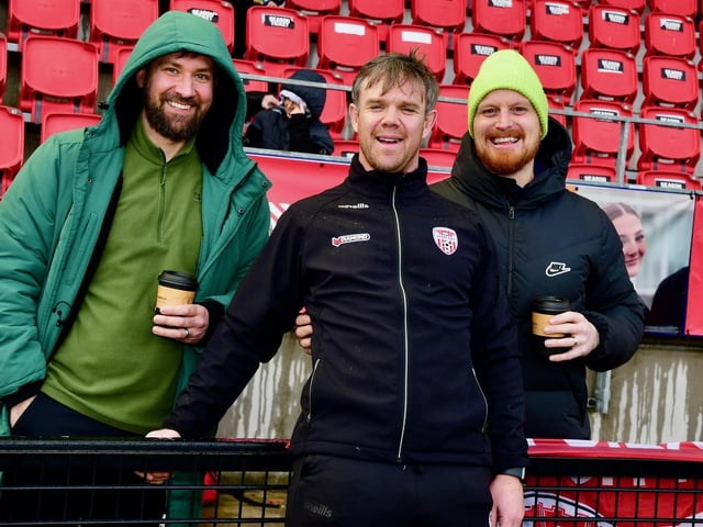 Derry City's strength and conditioning coach Kevin McCreadie shares a joke with these fans ahead of kick-off.