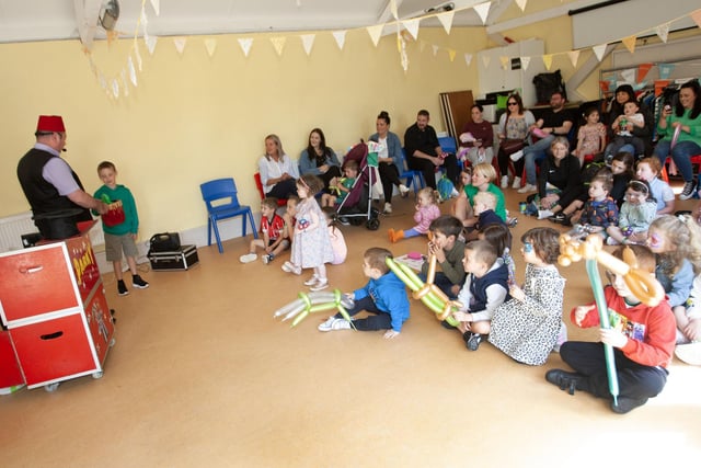 Magician Parky having fun with some of the parents and children at Friday's Fun Day.