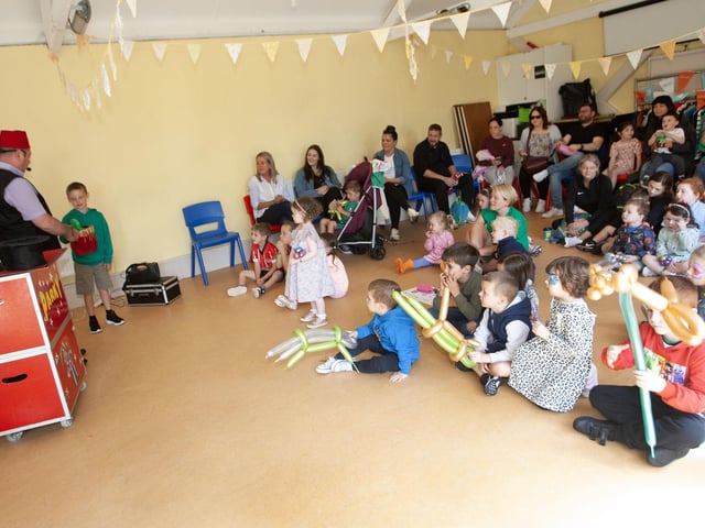 Magician Parky having fun with some of the parents and children at Friday's Fun Day.