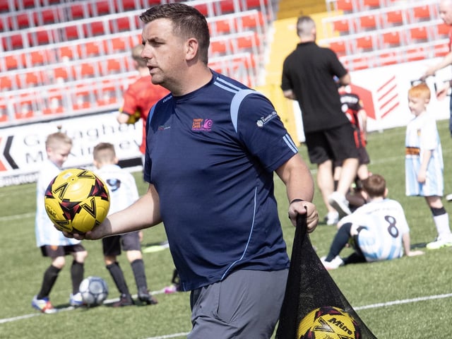Tournament organiser Mo Mahon making sure all games have footballs during Thurday's competition.