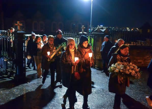 Relatives gather after mass at St Columba’s Church to take part in a wreath laying event, at Strabane Old Road, on the 50th Anniversary of the Annie’s Bar massacre on Tuesday evening. Photo: George Sweeney. DER2251GS – 17