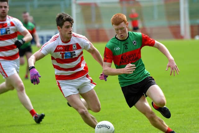 Doire Trasna Daniel Doherty is chased by Ballerin’s Jarlath Bradley during the Neil Carlin Cup Final, at Celtic Park, on Sunday afternoon. Photo: George Sweeney. DER23119GS – 04