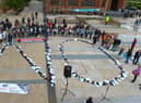 Footwear of victims of the troubles arranged to spell ‘NO’ at a protest against the proposed Northern Ireland Troubles (Legacy and Reconciliation) Bill, held in the Guildhall in 2022.  Photo: George Sweeney.  DER222GS – 015