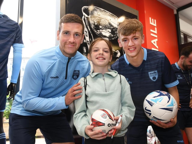 Derry City stars Patrick McEleney and Ciaron Harkin picTured with one of the youngsters who enjoyed meeting them at the O'Neills Superstore on Tuesday.