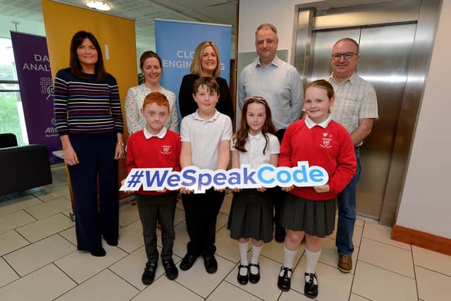 John Healy, then managing director of AllState, pictured several years ago with teachers and pupils from Drumachose Primary School, Limavady during a visit by the school to AllState in Springtown Business Park as part of the primary schools Time to Code Programme. DER1919GS-026