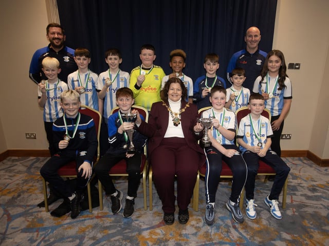 The Mayor, Patricia Logue. pictured at the D&D Youth FA Annual Awards at the City Hotel on Friday night presents Strabane Athletic U12s with the League and Summer Cup trophies. Included are coaches John Roulston and Chris McDaid.