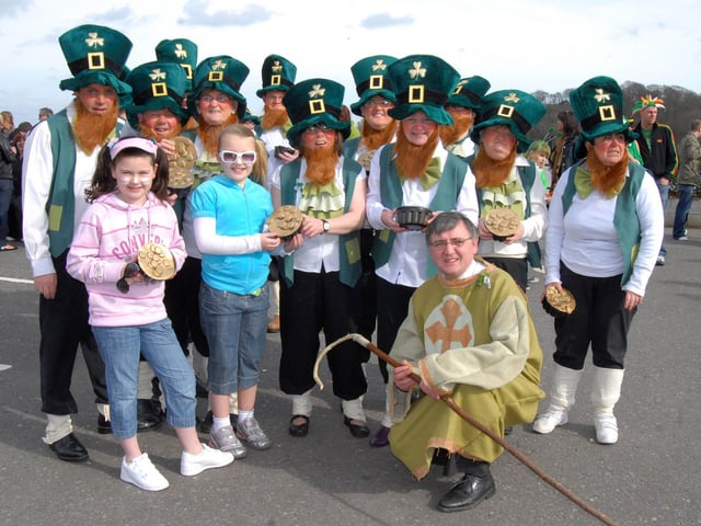 Jade Boardman and Chloe Coyle Millar pictured with the Destined leprechauns at the St Patrick's Day Parade in Derry. 1703Ap24
