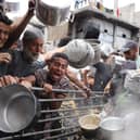 Palestinians struggle to get their food rations outside a crowded distribution centre in Beit Lahia in the northern Gaza Strip on May 15, 2025. Gaza rescuers said Israeli strikes and shelling on Thursday killed 82 people in the war-battered Palestinian territory, updating a previous toll. (Photo by BASHAR TALEB / AFP) (Photo by BASHAR TALEB/AFP via Getty Images)