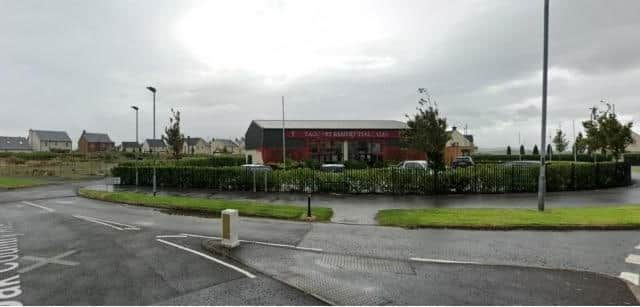 The vacant site and marketing house location where the apartments will be built.