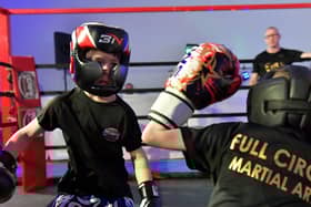 Cian Sharkey (on the left), from Strike Martial Arts, takes on Cabel McCann from Full Circle Martial Arts in The Rising Stars event held in Shantallow Community Centre on Saturday. Photo: George Sweeney. DER2308GS – 145