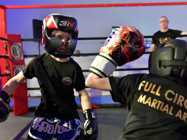 Cian Sharkey (on the left), from Strike Martial Arts, takes on Cabel McCann from Full Circle Martial Arts in The Rising Stars event held in Shantallow Community Centre on Saturday. Photo: George Sweeney. DER2308GS – 145
