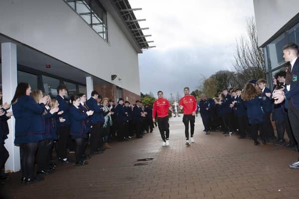 Derry City players Ciaran Coll and Jamie McGonigle get a guard of honour as they arrive at Oakgrove Integrated College with the FAI Cup.