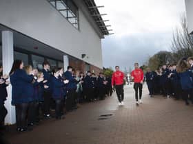 Derry City players Ciaran Coll and Jamie McGonigle get a guard of honour as they arrive at Oakgrove Integrated College with the FAI Cup.
