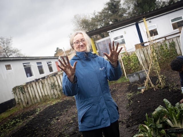 Teacher Angela Beattie is not afraid to get her hands dirty during Friday's 'Gardening Course' at Hollybush PS, Derry.