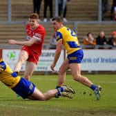 Niall Higgins and David Murray of Roscommon close in on Derry’s Lachlan Murray.  Photo: George Sweeney
