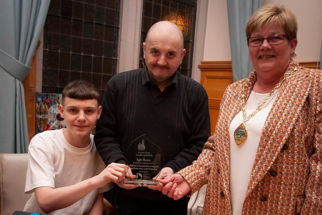 The Deputy Mayor of Derry City and Strabane District Council, Angela Dobbins making a special presentation to Derry teenager Kyle Moore in recognition of his recent success in the WAKO World Championships in Italy and his gold medal success at the Bristol Open, during a reception in his honour at the Mayor’s Parlour, Guildhall on Thursday night last. Included centre is Kyle’s coach Gary Kelly.

