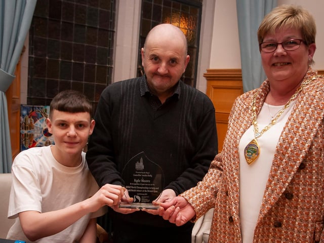 The Deputy Mayor of Derry City and Strabane District Council, Angela Dobbins making a special presentation to Derry teenager Kyle Moore in recognition of his recent success in the WAKO World Championships in Italy and his gold medal success at the Bristol Open, during a reception in his honour at the Mayor’s Parlour, Guildhall on Thursday night last. Included centre is Kyle’s coach Gary Kelly.