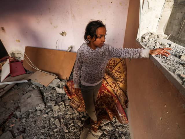 A girl reacts standing in a house destroyed by Israeli bombardment in Rafah refugee camp, south of the Gaza Strip, on January 1, 2024, amid the ongoing conflict between Israel and the Palestinian militant group Hamas. (Photo by AFP) (Photo by -/AFP via Getty Images)