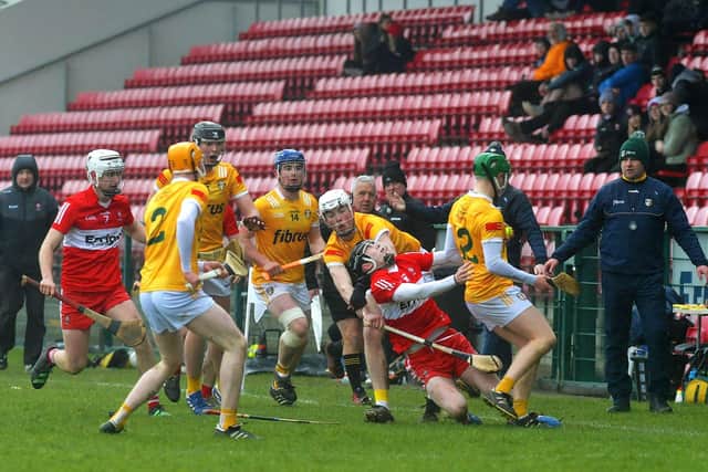 Derry’s Eamon Cassidy is brought to ground by Antrim players during the Ulster U20 Hurling Cup Final at Owenbeg on Saturday. Photo: George Sweeney. DER2310GS – 118