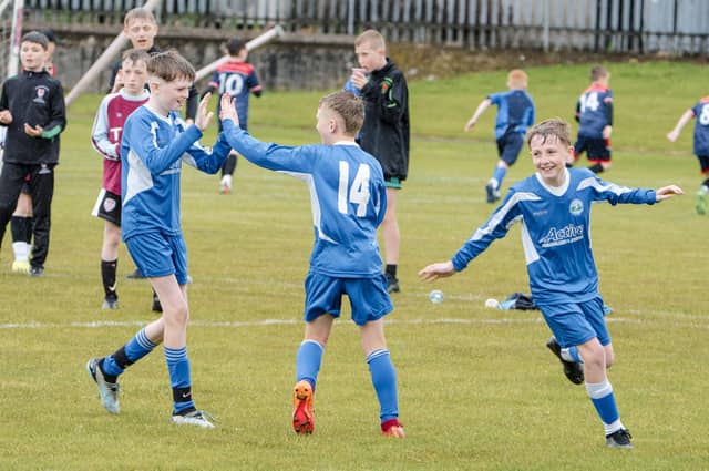 Long Tower PS players celebrate a goal during Thursday's Sean O'Kane Primary Schools Cup at St. Joseph's Boys School. (Photo: Jim McCafferty)