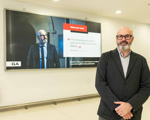 Aaron Coffey (Contracts Manager) with his digital billboard at Belfast City Airport