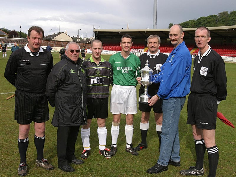 Brian Kelly (brother) presents the Terry Kelly Memorial Cup to Mark Doherty (third from left) captain Oak Leaf. Included are from left Noel Moore, Jimbo Crossan, chairman of the Derry & District, Michael McMenamin, captain of Bluebell Celtic, Noel O'Donnell, referee and Jim mcGuinness referee's assistant.