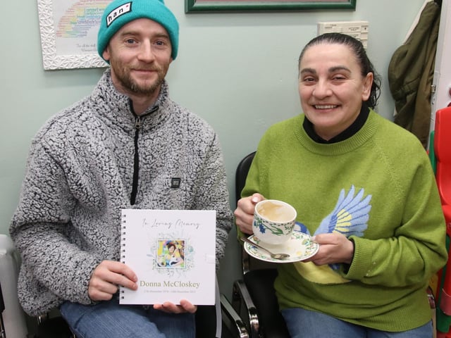 Paul Lowry and Janet Strawbridge pictured with a beautiful Memory Book for their late colleague Donna. (Photo - Deirdre Heaney, nwpresspics) : .