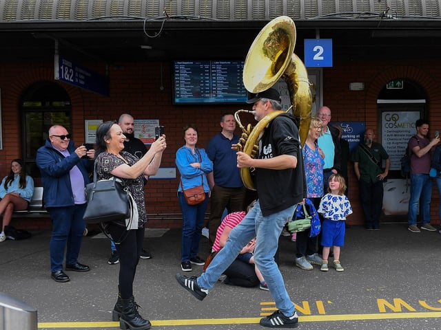 The Jaydee Brass Band’s Patrick Witberg entertaining passengers at the Foyle Street Bus station. Photo: George Sweeney