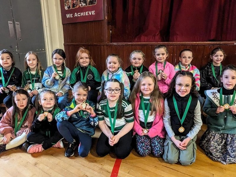 These young camogie players proudly show off their medals.