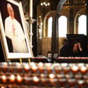 A person pays their respects inside The Metropolitan Cathedral of the Most Precious Blood, informally known as Westminster Cathedral, in central London on April 21, 2025, following the news of the death of Pope Francis. Pope Francis died on April 21, 2025 aged 88, a day after making a much hoped-for appearance at Saint Peter's Square on Easter Sunday, the Vatican said in a statement. (Photo by HENRY NICHOLLS / AFP) (Photo by HENRY NICHOLLS/AFP via Getty Images)
