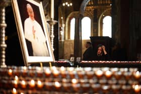 A person pays their respects inside The Metropolitan Cathedral of the Most Precious Blood, informally known as Westminster Cathedral, in central London on April 21, 2025, following the news of the death of Pope Francis. Pope Francis died on April 21, 2025 aged 88, a day after making a much hoped-for appearance at Saint Peter's Square on Easter Sunday, the Vatican said in a statement. (Photo by HENRY NICHOLLS / AFP) (Photo by HENRY NICHOLLS/AFP via Getty Images)