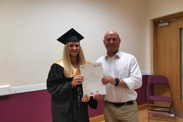 Aisling Starrs receiving her level six certificate from Tommy McAuley of the Department of Communities.
