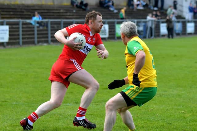 The Derry Masters’ Eamon Murphy evades a tackle during the game against Donegal Masters at O’Cahan Park on Saturday afternoon.  Photo: George Sweeney. DER23118GS – 86