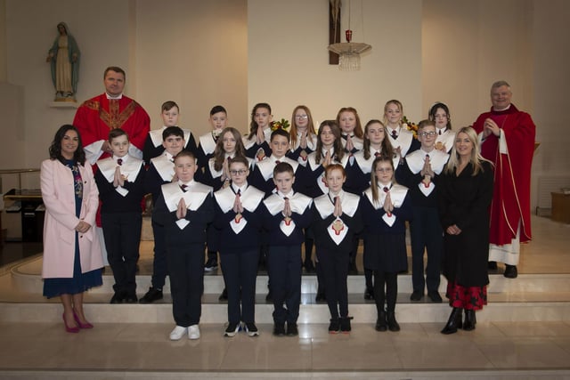 Children from Holy Child PS, Creggan who received the Sacrament of Confirmation from Fr. Daniel McFaul at St. Mary’s Church, on Friday afternoon last. Included from left are Mrs. Pat Concannon, Principal, Fr. Ignacy, and on right, Miss Colleen McBrearty, teacher. (Photo: Jim McCafferty Photography)